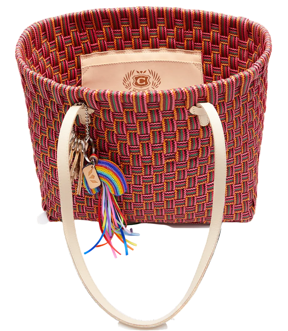 Woven bag with colorful tassels and keys on a white background