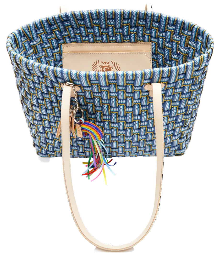 Blue woven tote bag with rainbow charm on a white background