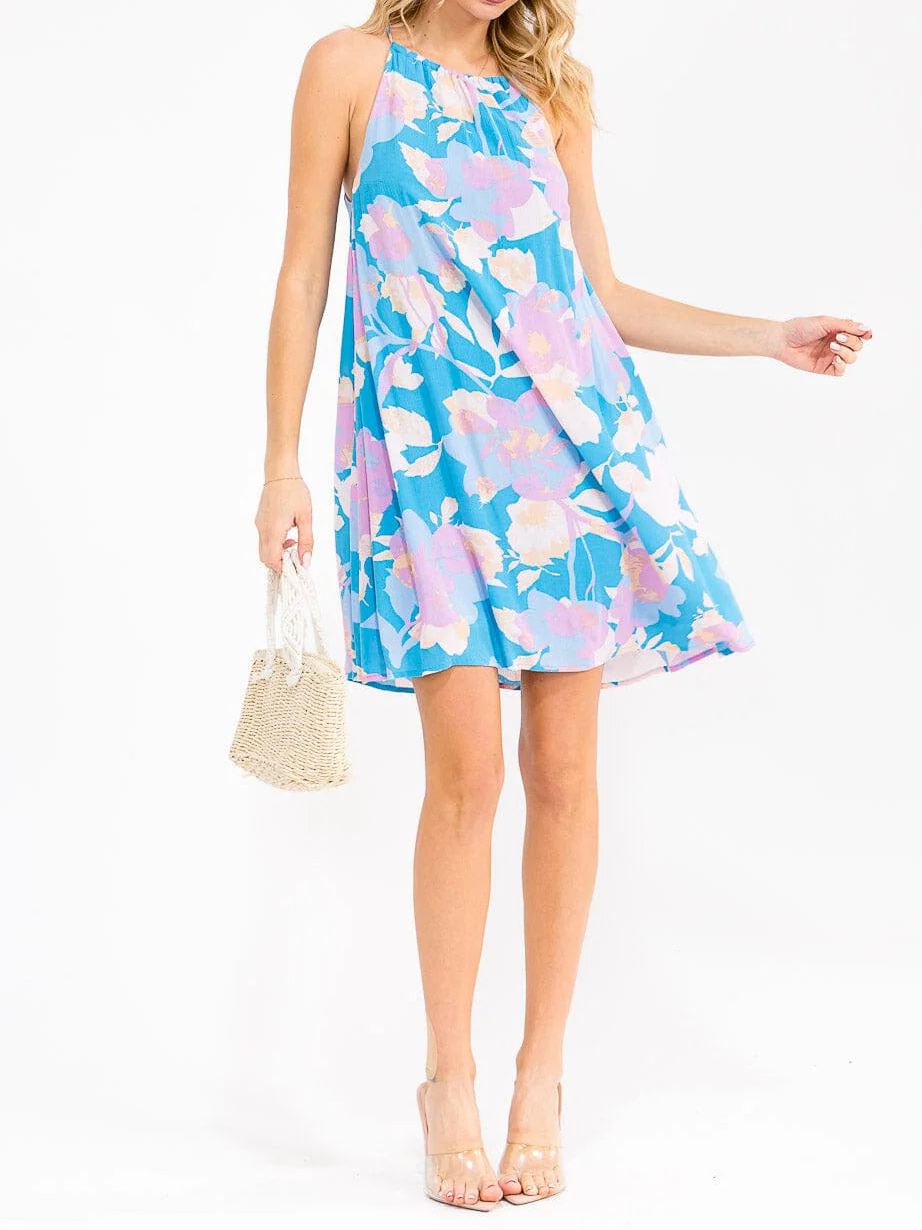 Woman wearing a blue floral dress on a white background