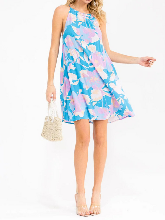 Woman wearing a blue floral dress on a white background