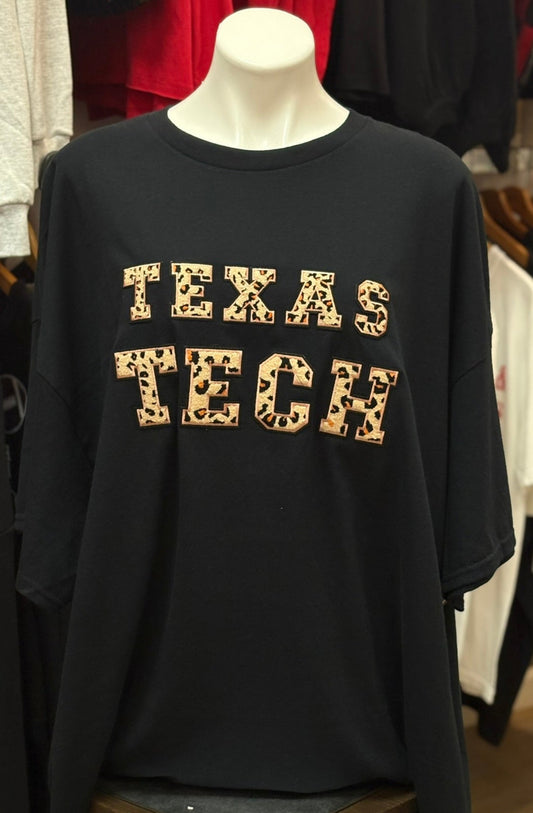 Black sweatshirt with 'TEXAS TECH' printed on it, displayed on a mannequin in a store setting.