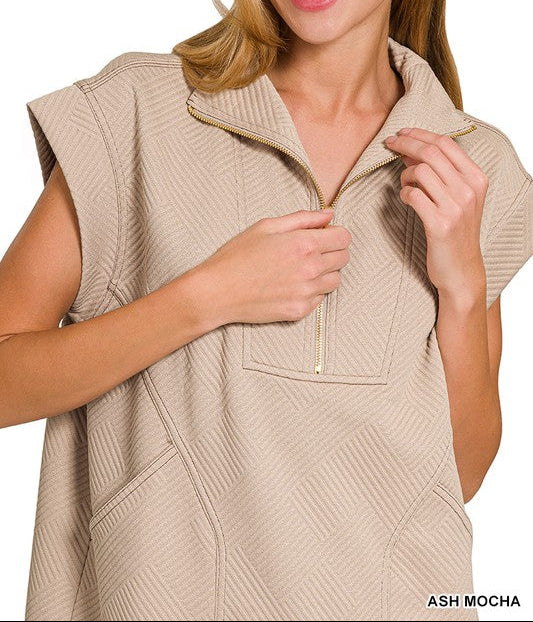 Woman wearing a beige vest with a white background