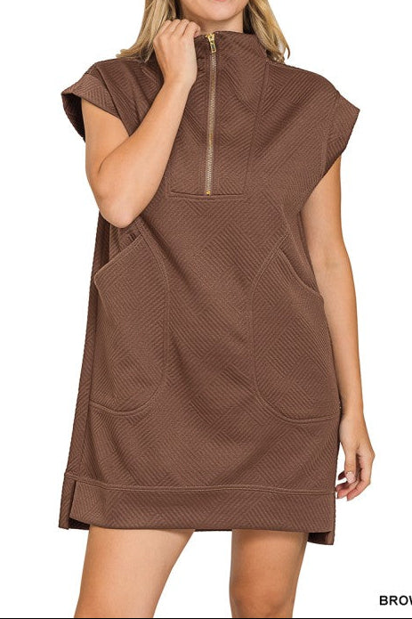 Woman wearing a brown sleeveless hoodie dress on a white background