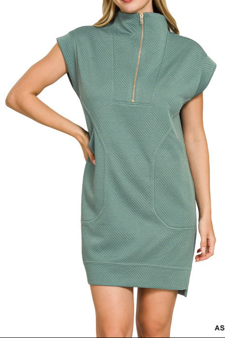 Woman wearing a green dress with a zipper on a white background