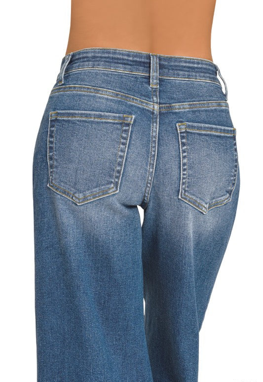 Rear view of a person wearing blue denim jeans with a faded wash, showing the back pockets and waistband against a plain white background. The word 'DARK' appears in the bottom right corner.