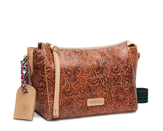 Brown leather handbag with floral patterns on a white background