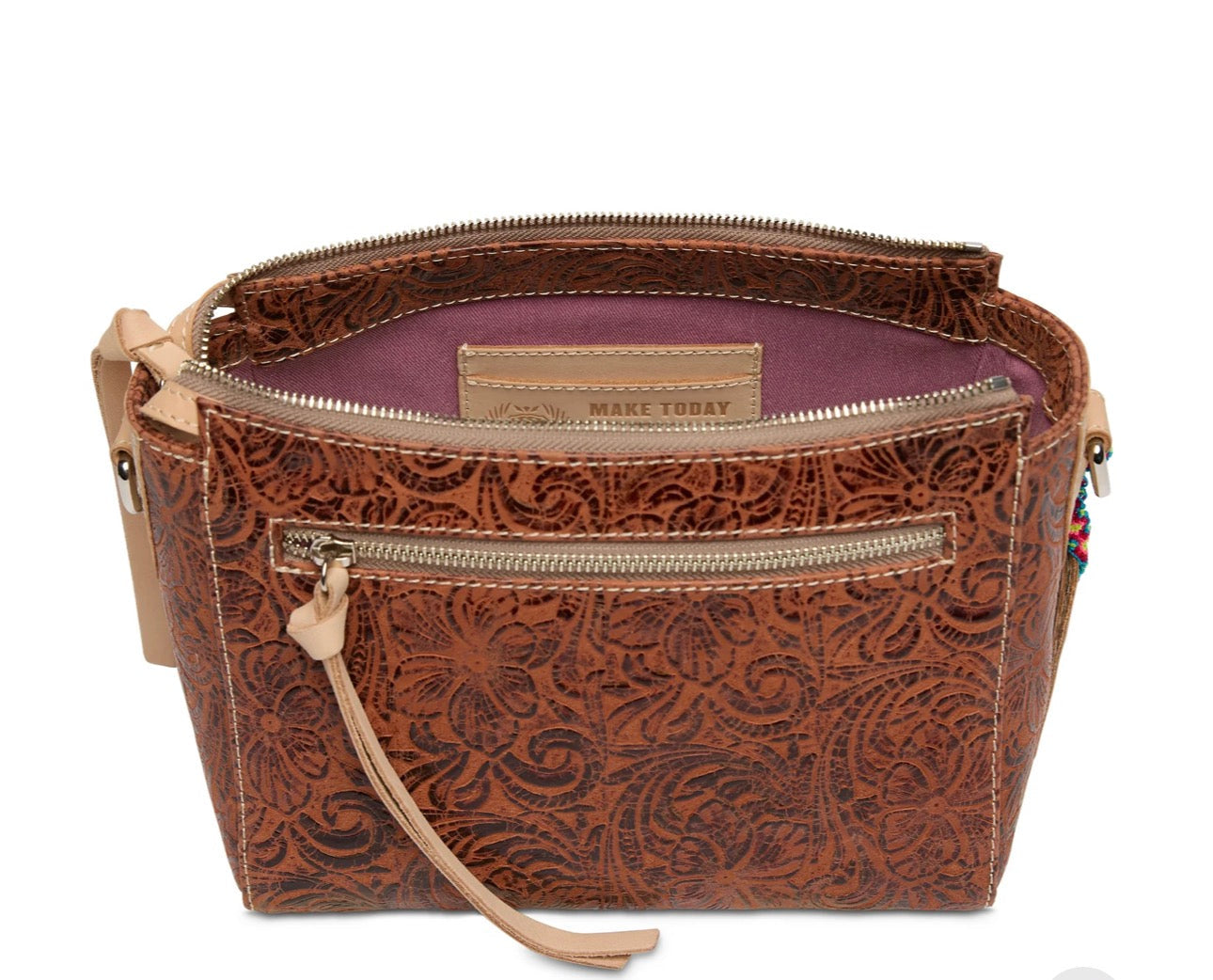 Brown leather handbag with paisley pattern on a white background