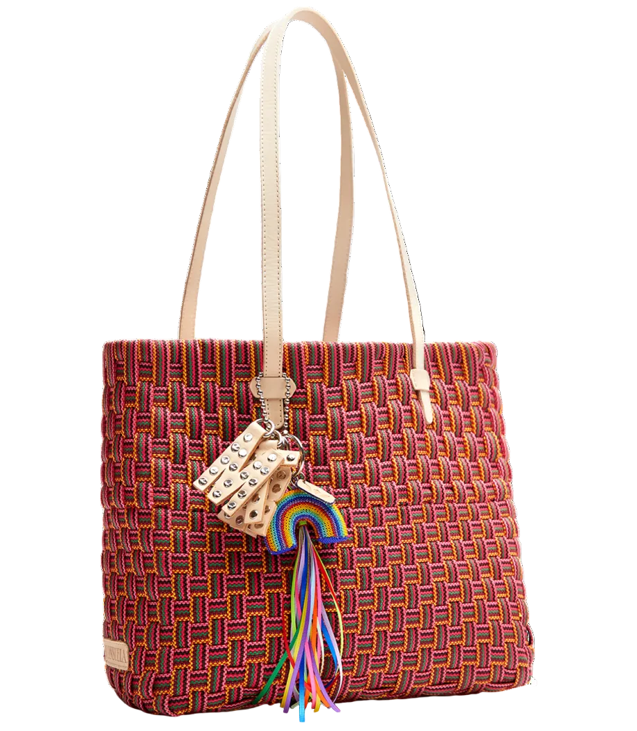 Multicolored woven handbag with a decorative charm on a white background