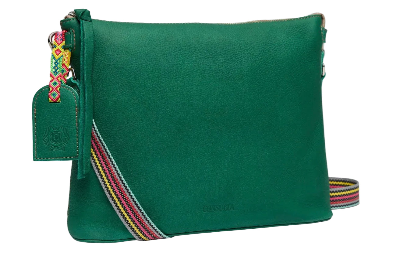 Green leather bag with colorful strap on a white background
