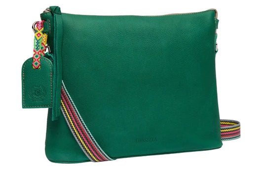 Green leather bag with colorful strap on a white background