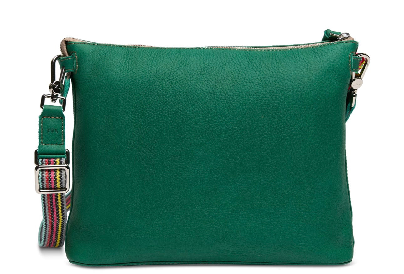 Green leather crossbody bag with a colorful strap on a white background