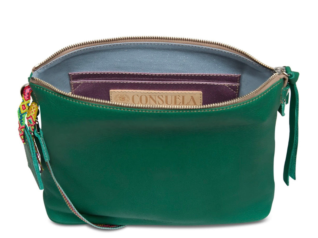 Green handbag with a visible brand label on a white background