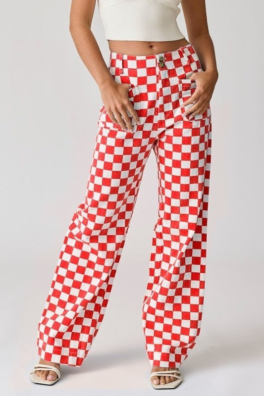 Person wearing red and white checkered pants on a plain background