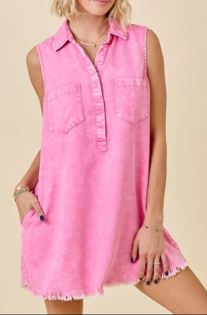 Woman wearing a pink sleeveless dress against a beige background