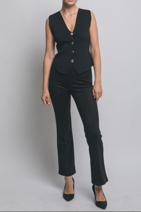 Woman wearing a black suit on a gray background