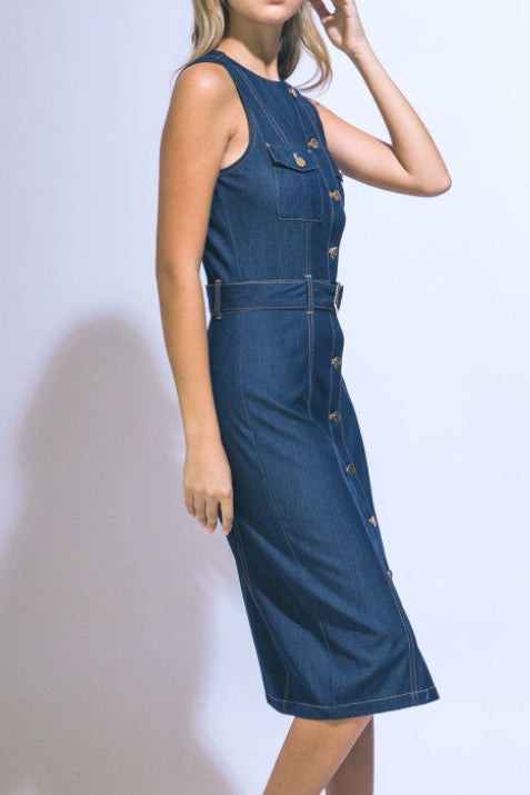 Woman wearing a blue denim dress against a white background