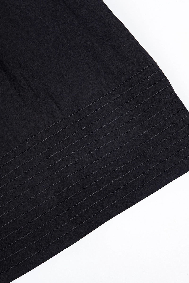 Close-up of a black fabric texture on a white background