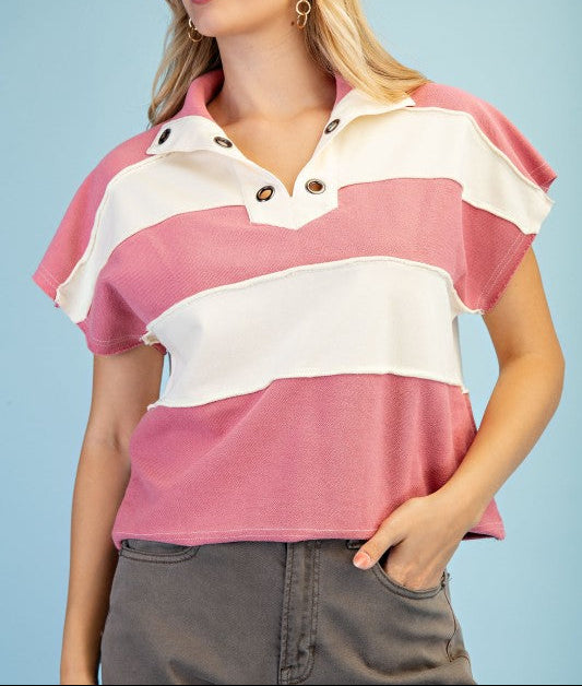Woman wearing a pink and white striped shirt against a light blue background