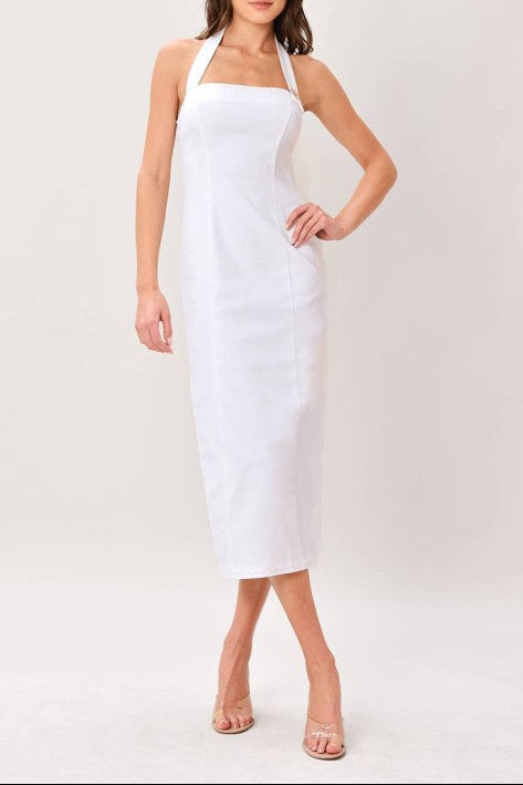 Woman wearing a white halter neck dress on a plain background