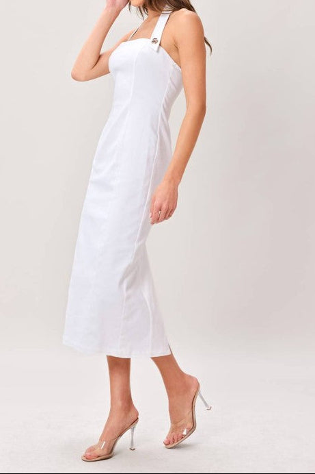 Woman wearing a white dress against a plain background