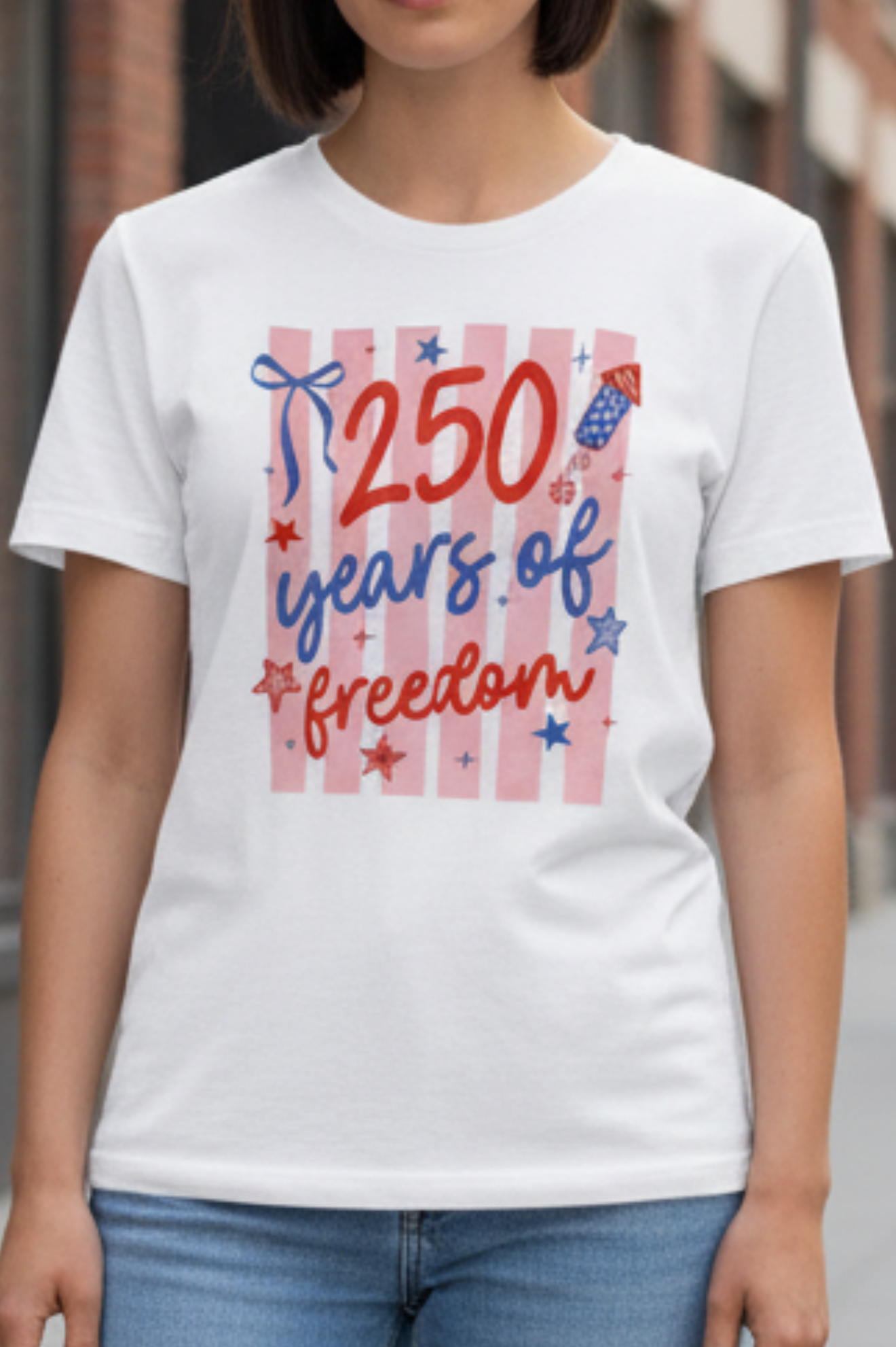 Woman wearing a white t-shirt with '250 years of freedom' design in an urban setting