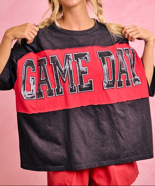 Woman wearing a 'GAME DAY' shirt against a pink background
