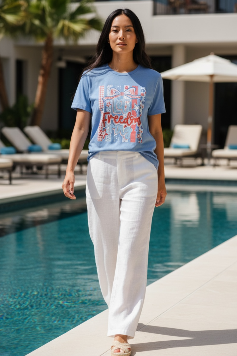 Woman wearing a blue t-shirt with a graphic design by a poolside.