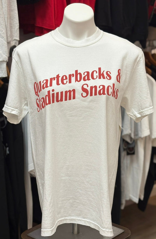 White t-shirt with red text on a mannequin in a store setting