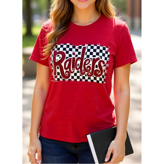 Person wearing a red t-shirt with 'Raiders' print outdoors