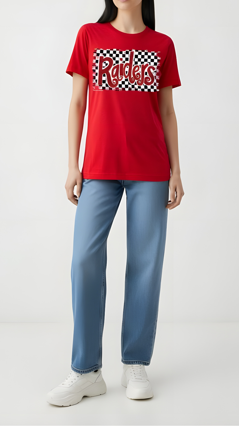 Person wearing a red t-shirt with a logo and light blue jeans on a white background
